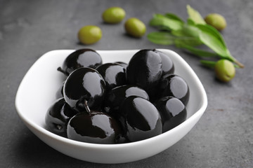 Bowl with black olives on kitchen table