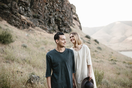 young fashionable couple laughing together in desert