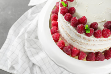 Delicious cake with raspberries on fabric