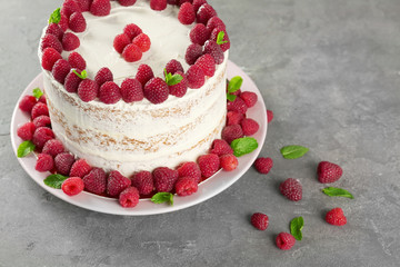 Delicious cake with raspberries on grey background