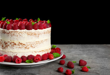 Delicious cake with raspberries on dark background