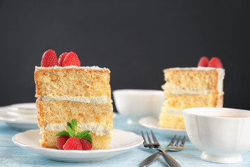 Slice of delicious cake with raspberries on plate