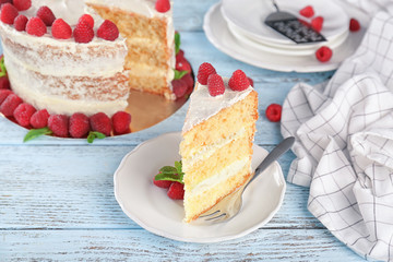 Slice of delicious cake with raspberries on plate