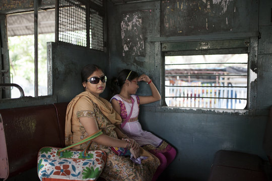 A mother and daughter traveling in Indian local Train