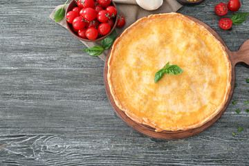 Delicious meat pie on wooden table