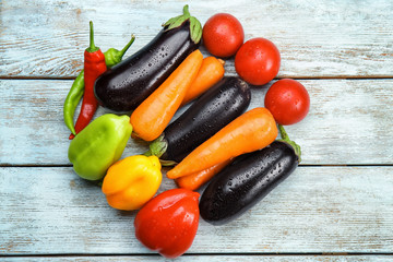 Composition with fresh vegetables on wooden background