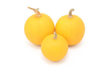 Three smooth-skinned orange ornamental gourds
