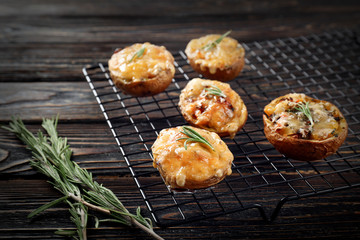 Baked stuffed potatoes on metal grid
