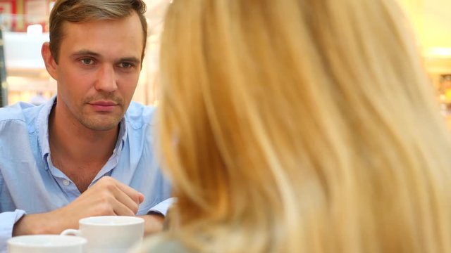 couple in cafe. beautiful Man and beautiful woman quarrel. 4k, slow-motion, close-up. copy space