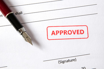 Approved stamp on document. Empty signature field, fountain pen