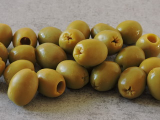 A bunch of olives on a light gray background. Copy space. Top view.