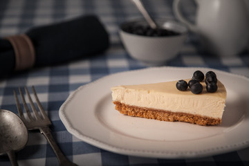 cheesecake on a plate with blueberries