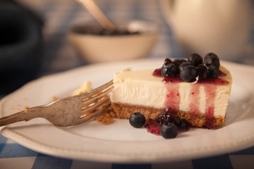 cheesecake on a plate with blueberries