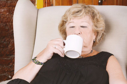 Old woman drinking coffee.