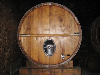 Wooden barrel with wine in cellar