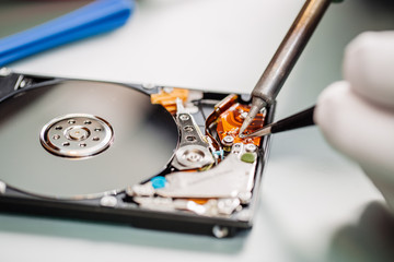 man repairing hard drive in service center. Repairing and fixing service in lab. Electronics repair...