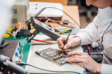 woman repairing computer hardware in service center. Repairing and fixing service in lab....