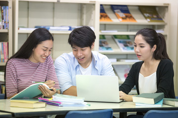 Group of Student Seaching information in the library with attractive smiling together. People with Education concept.