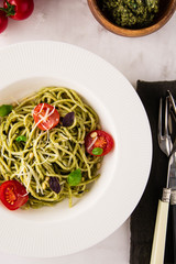 Spaghetti with homemade pesto. Pasta with pesto and herbs.
