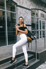 beautiful young girl drinking coffee in the city