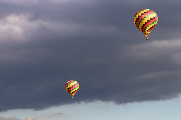 Colorful hot air balloon with puffy clouds in background