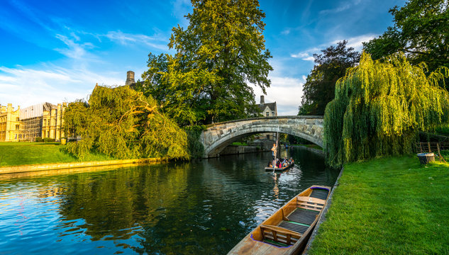 Tourists on punt trip (sightseeing with boat) along River Cam near Kings College in the city of Cambridge, United Kingdom