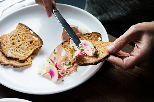 Pate being spread on toast