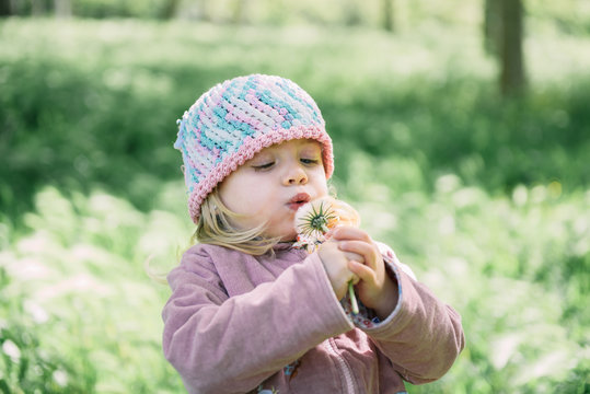 Cute little blonde girl playing in the parc