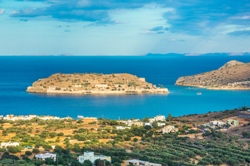 Fototapeta na wymiar View of the island of Spinalonga at sunset with nice clouds and calm sea. Here were isolated lepers, humans with the Hansen's desease and took place the story of Victoria 's Hislop novel 