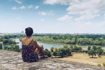 Naklejka na ściany i meble Girl looking the view of Sava and Danube rivers, on Belgrade, Serbia.
