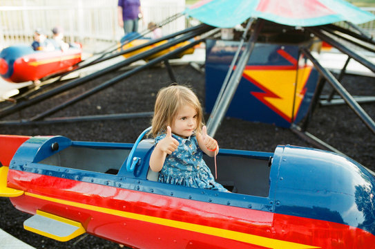child on ride at amusement park