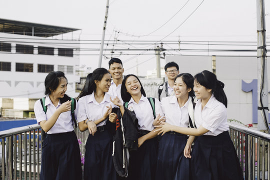 Thai students walking together on the bridge in Bangkok