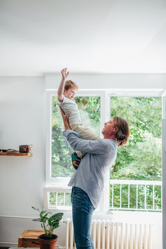 Man with son playing at home