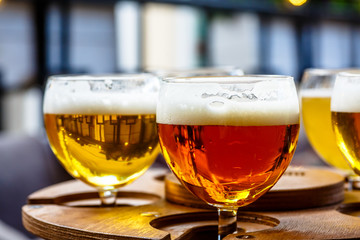 Different varieties of red beer poured in glasses.
