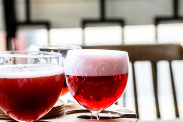 Different varieties of red beer poured in glasses.