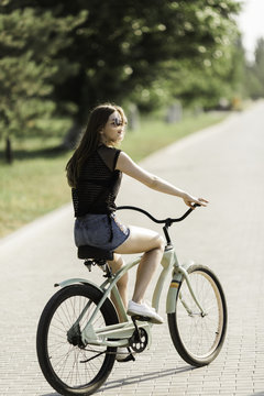 Happy Young Woman Riding a Bike