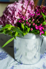 bouquet in a metal vase on a table
