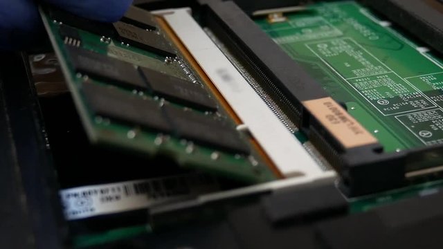 Ram memory dimm in notebook in the service center for repair and upgrade. Green microchip of Laptop