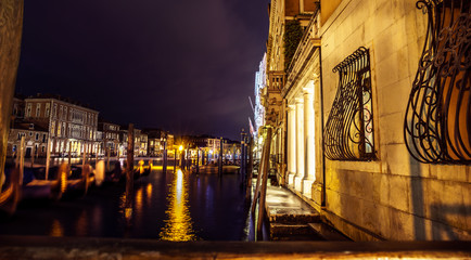 Panorama of Grand Canal after dusk with blurry gondola on the foreground, Italy