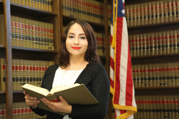 Portrait of a young female professional, woman lawyer in law library