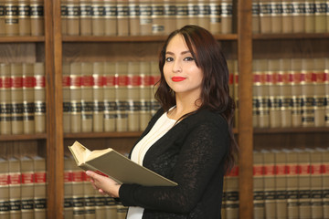 Portrait of a young female professional, woman lawyer in law library