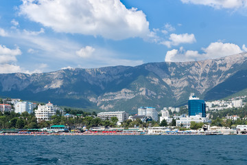 Fototapeta premium Views of the Crimean coastline with hotels and beaches with mountains in the background.