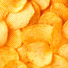 background of crispy golden chips with ribbed texture, seasoned, with sunlight. Frame for wallpapers, background, and texture. Square