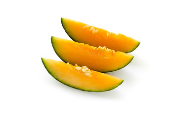Fototapeta na wymiar Three cut pieces of ripe yellow melon. With seeds. Isolated on white background