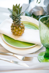 plate decorated with a pineapple, glass and decor, green and white colour