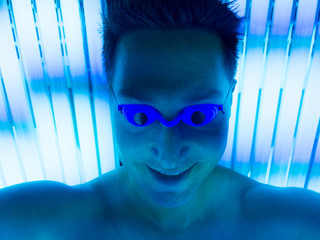 Selfie of man in tanning bed