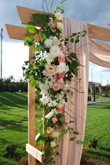 Arch for the wedding ceremony, decorated cloth flowers greenery. Wedding rustic decoration.