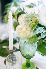 glass with candle and decor, green and white colour