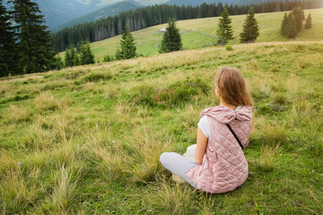 Happy woman relaxing outdoors in the mountains