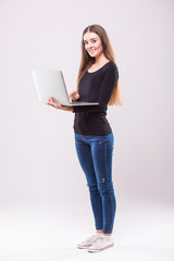 Brunette Woman with laptop and thumb up on white background